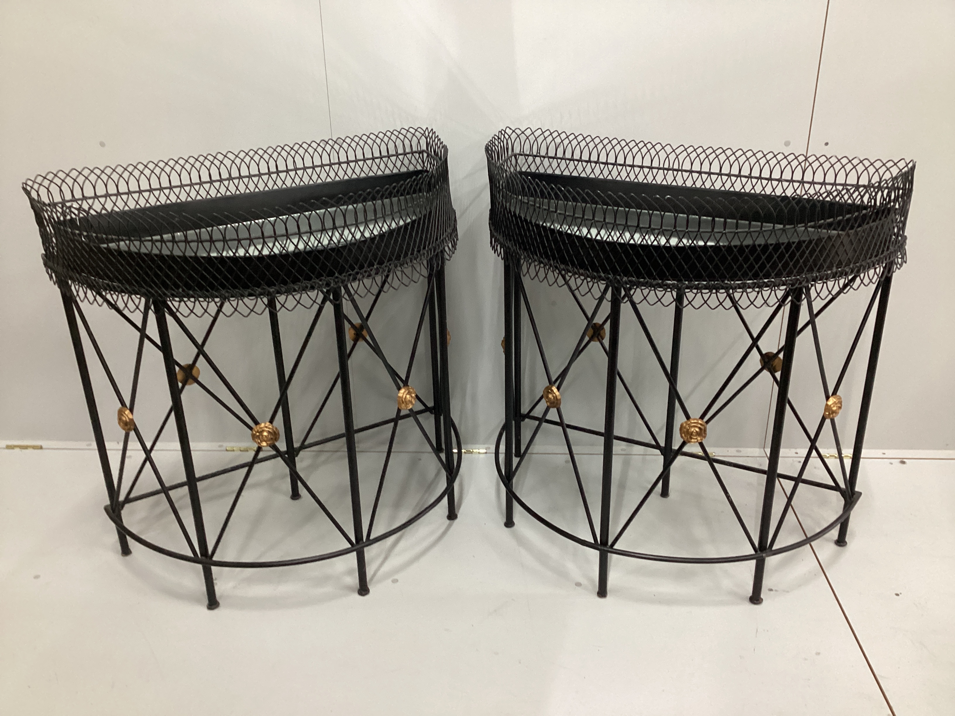 A pair of contemporary wrought iron and wirework 'D' shaped console tables with mirrored tray inserts, width 94cm, depth 52cm, height 94cm